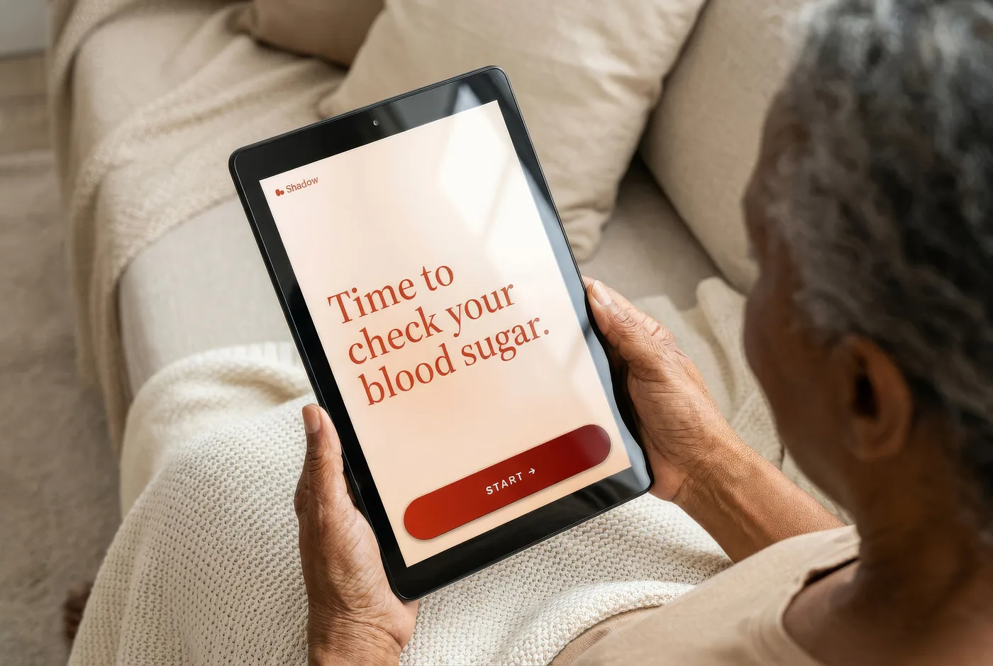 An older adult following a blood sugar instruction on Shadow’s dedicated tablet
